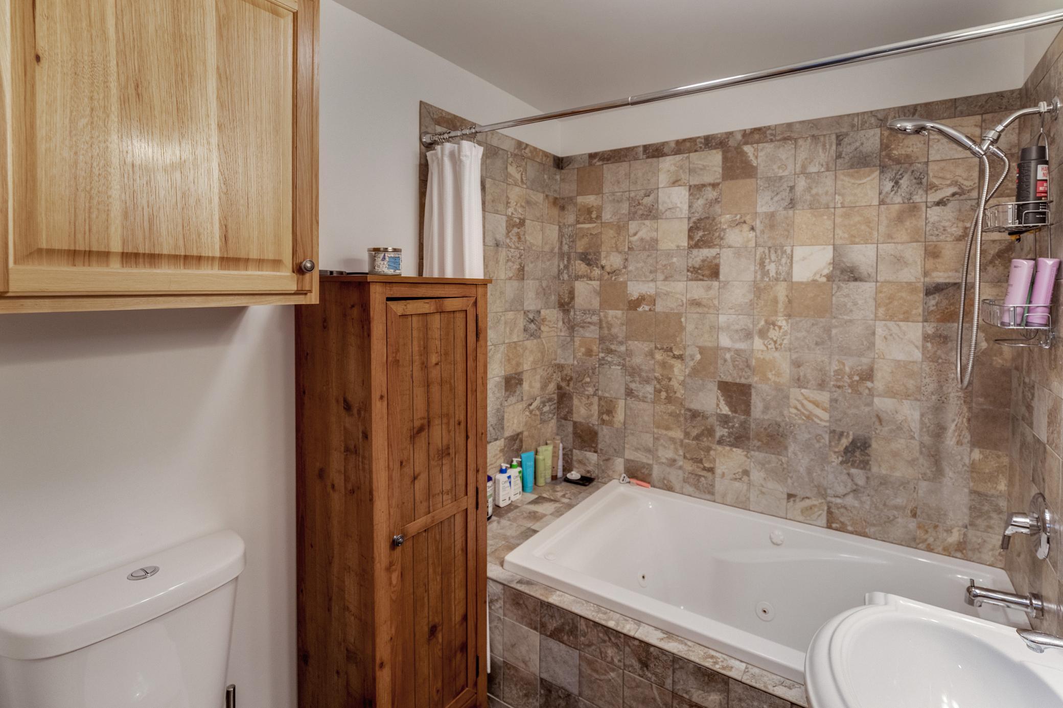 Full bath with jetted tub and shower in house 1