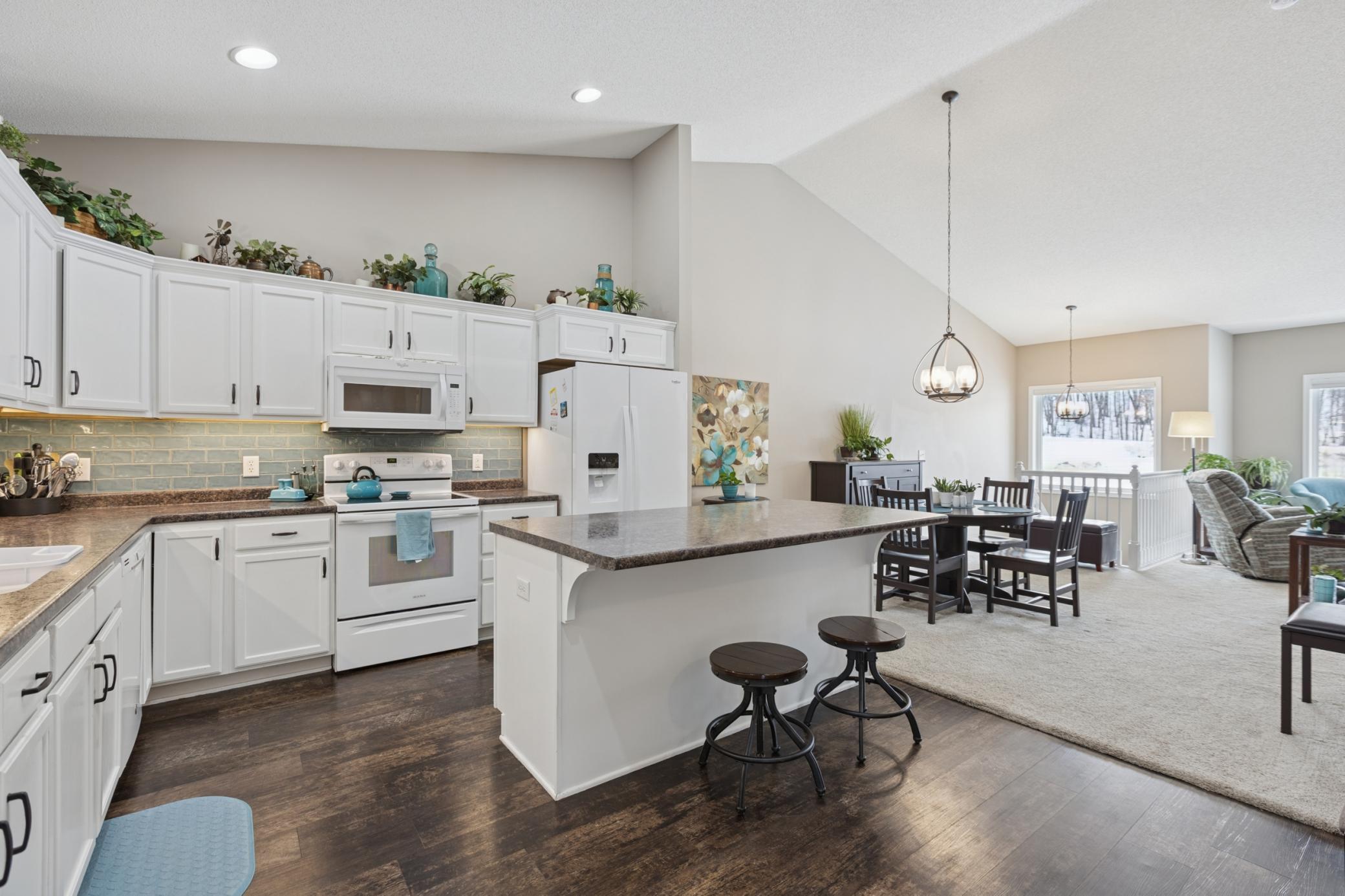 Another view of the kitchen. This home has high vaulted ceilings and and open floor plan.
