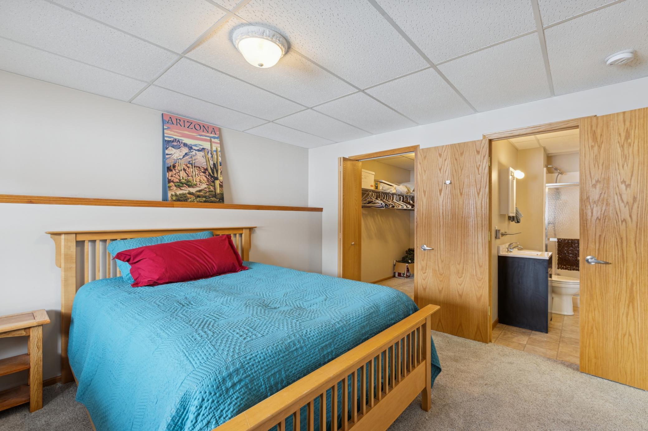 The lower-level bedroom walks through to the bathroom and has a large walk-in closet.