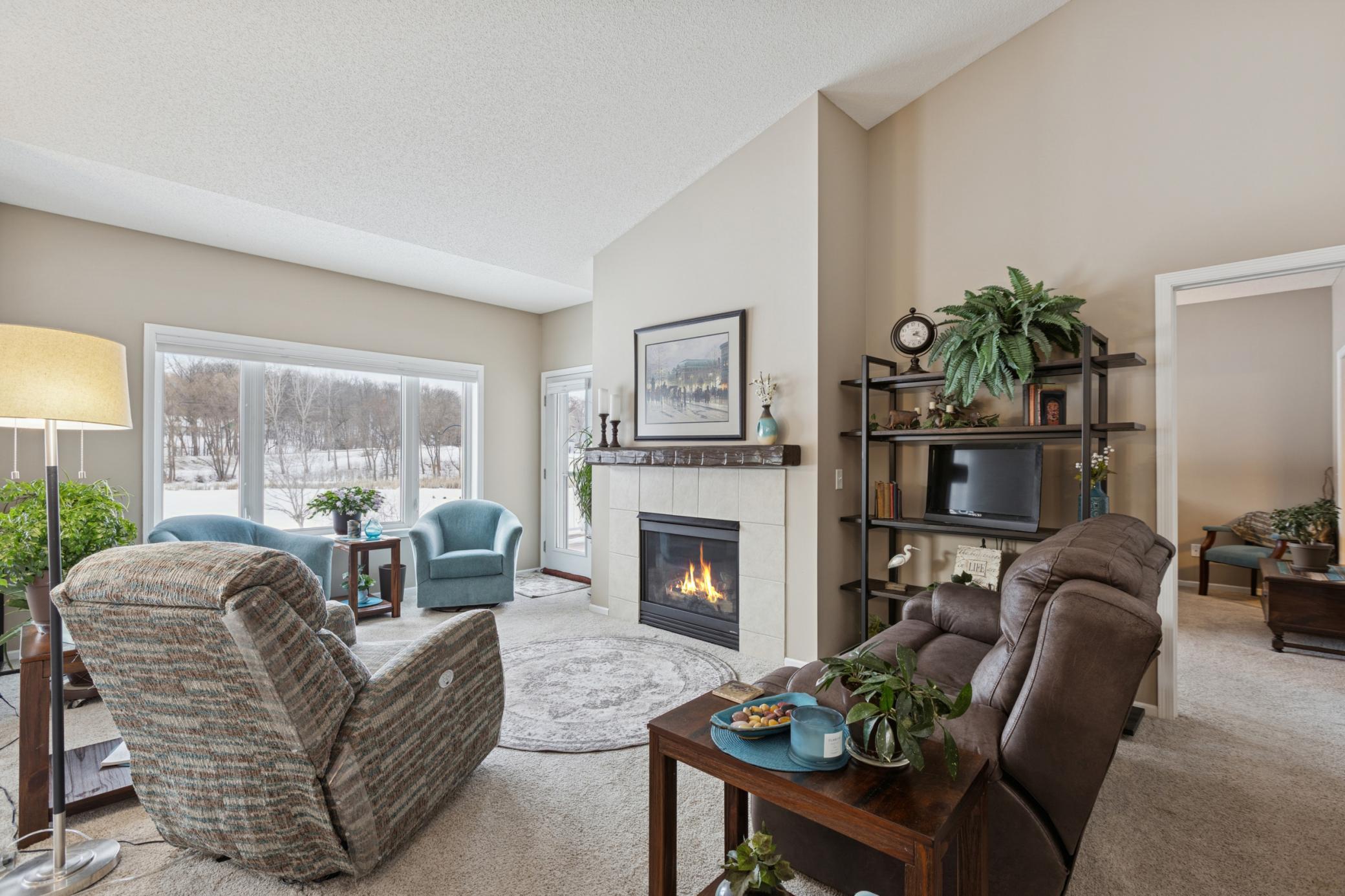 The living room with walk out to the deck. Both have beautiful views of the pond.