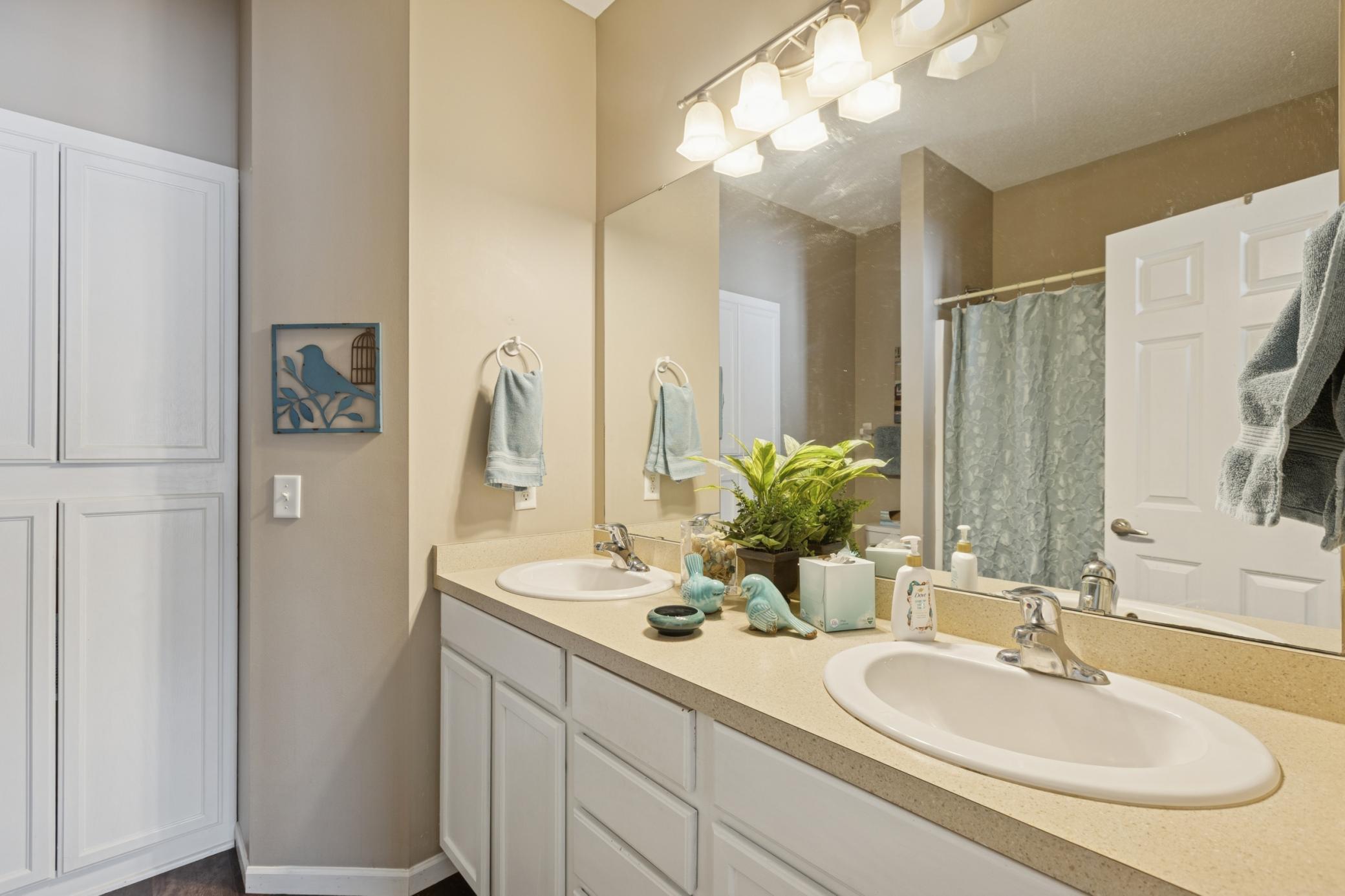 The primary bathroom with double sinks, bath/shower combination and large linen closet.