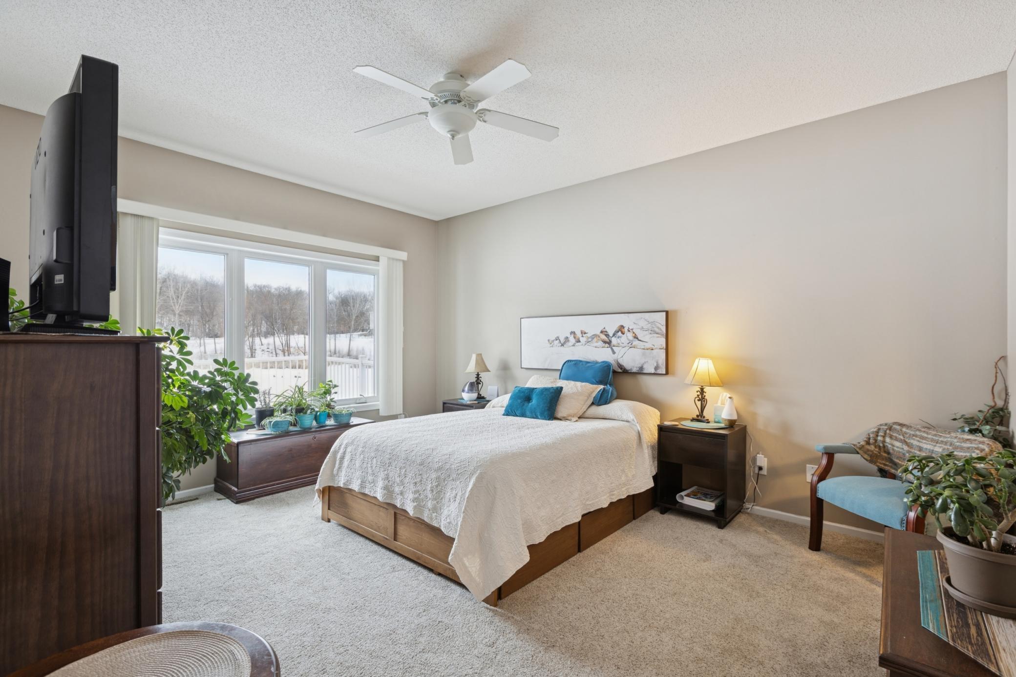 The primary bedroom overlooks the pond.
