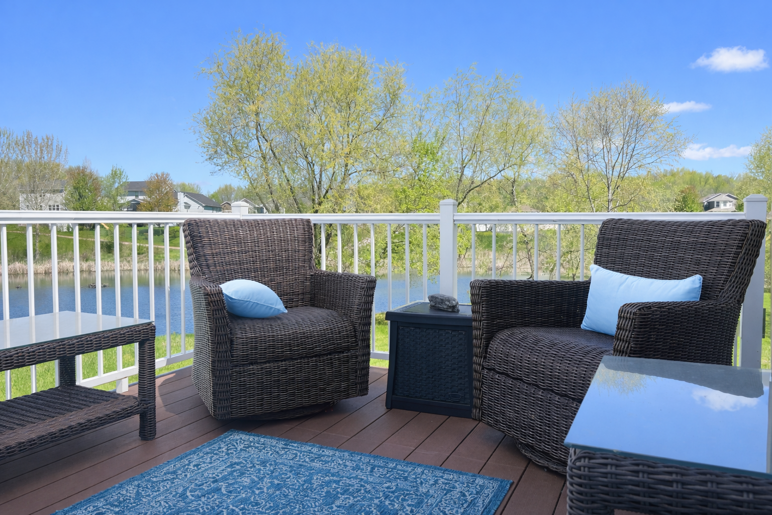 The deck overlooking the pond. The deck floor is a composite material and the railing is metal.