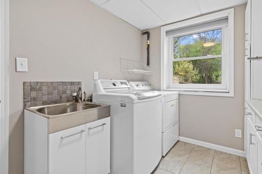 Laundry Room, located down stairs with a lot of storage space, Tile floors and great sink area.