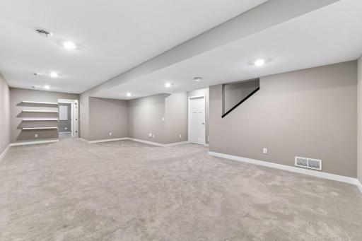 The finished lower level adds even more living space with an expansive family room, guest bedroom, and a three-quarter bathroom.