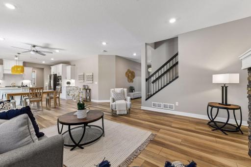 The open main floor includes an inviting living room with gas fireplace, center island eat-in kitchen, walk-in pantry, office, and large mudroom.