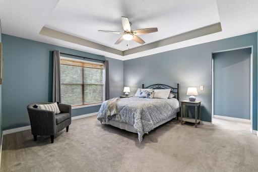 The upper level offers a luxurious primary suite with a box-vaulted ceiling and private full bathroom, three additional bedrooms, bonus room, and laundry room.