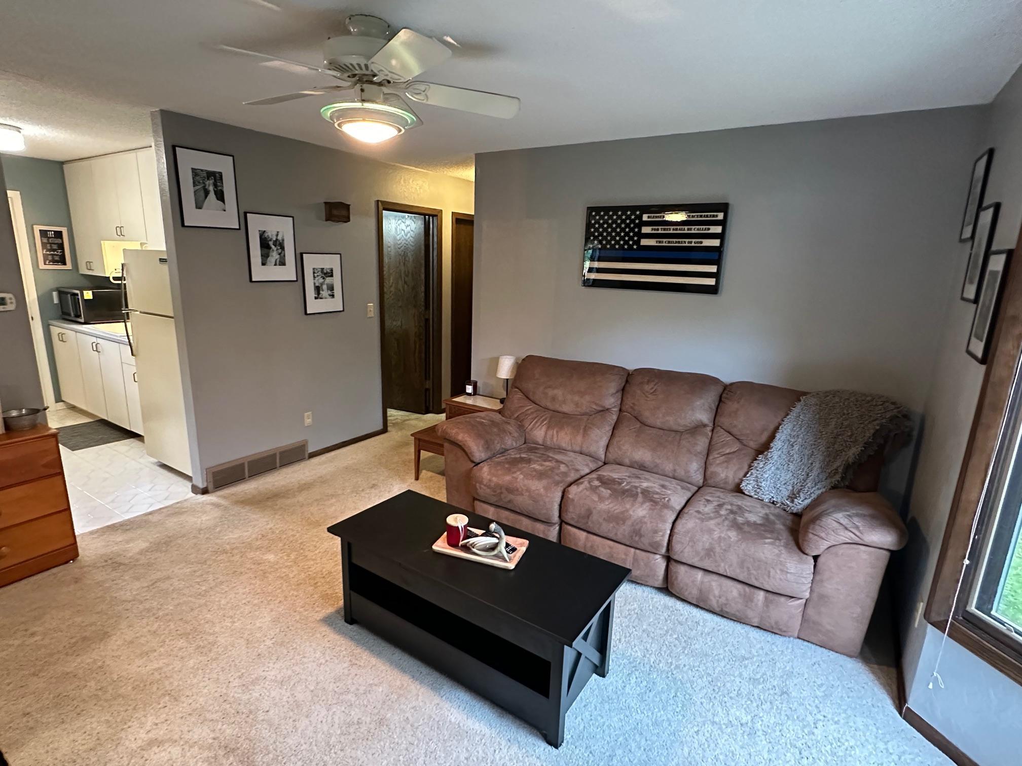 Alternate view of living room looks into the kitchen