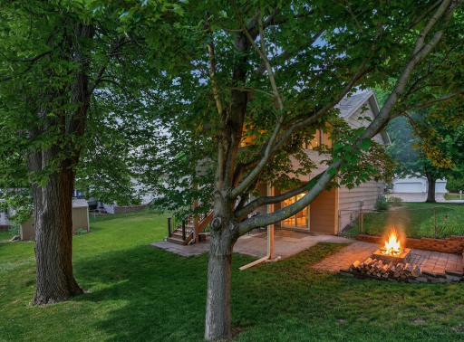 Mature trees provide privacy in the sunroom, a spacious patio & a dedicated fire pit!