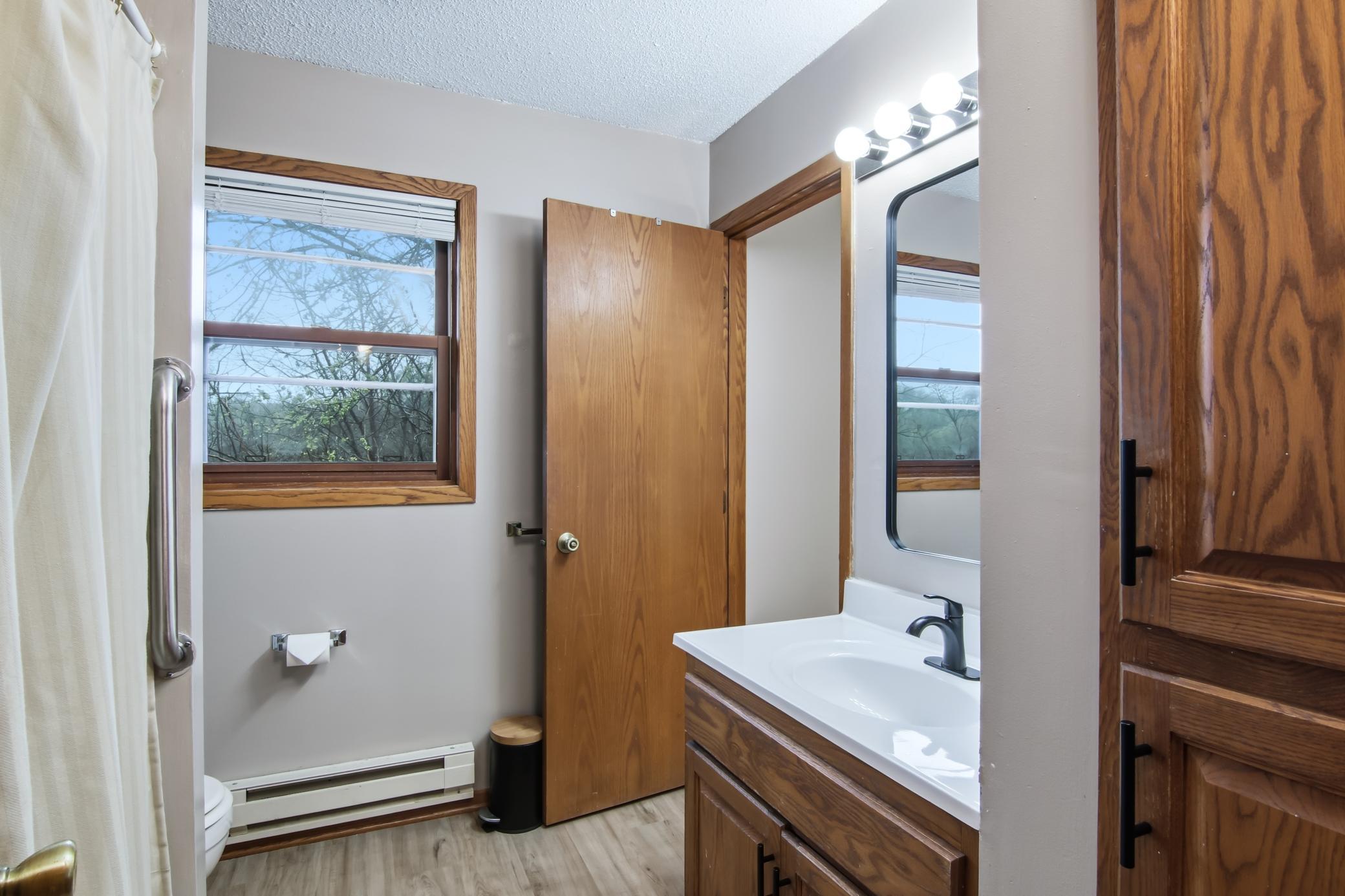 Upper level bath has a new sink/counter/faucet.