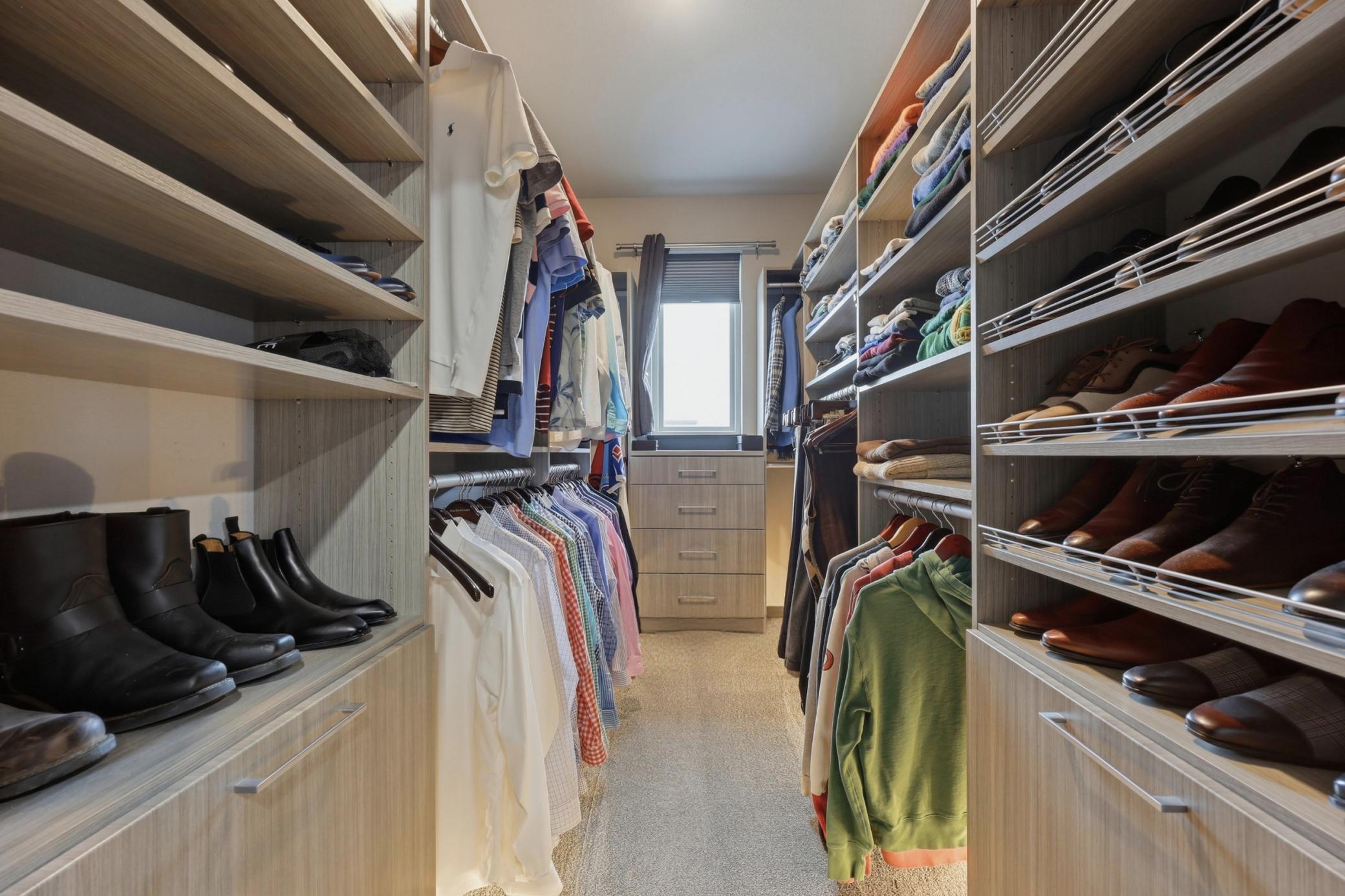 large custom closet with toe kick lighting