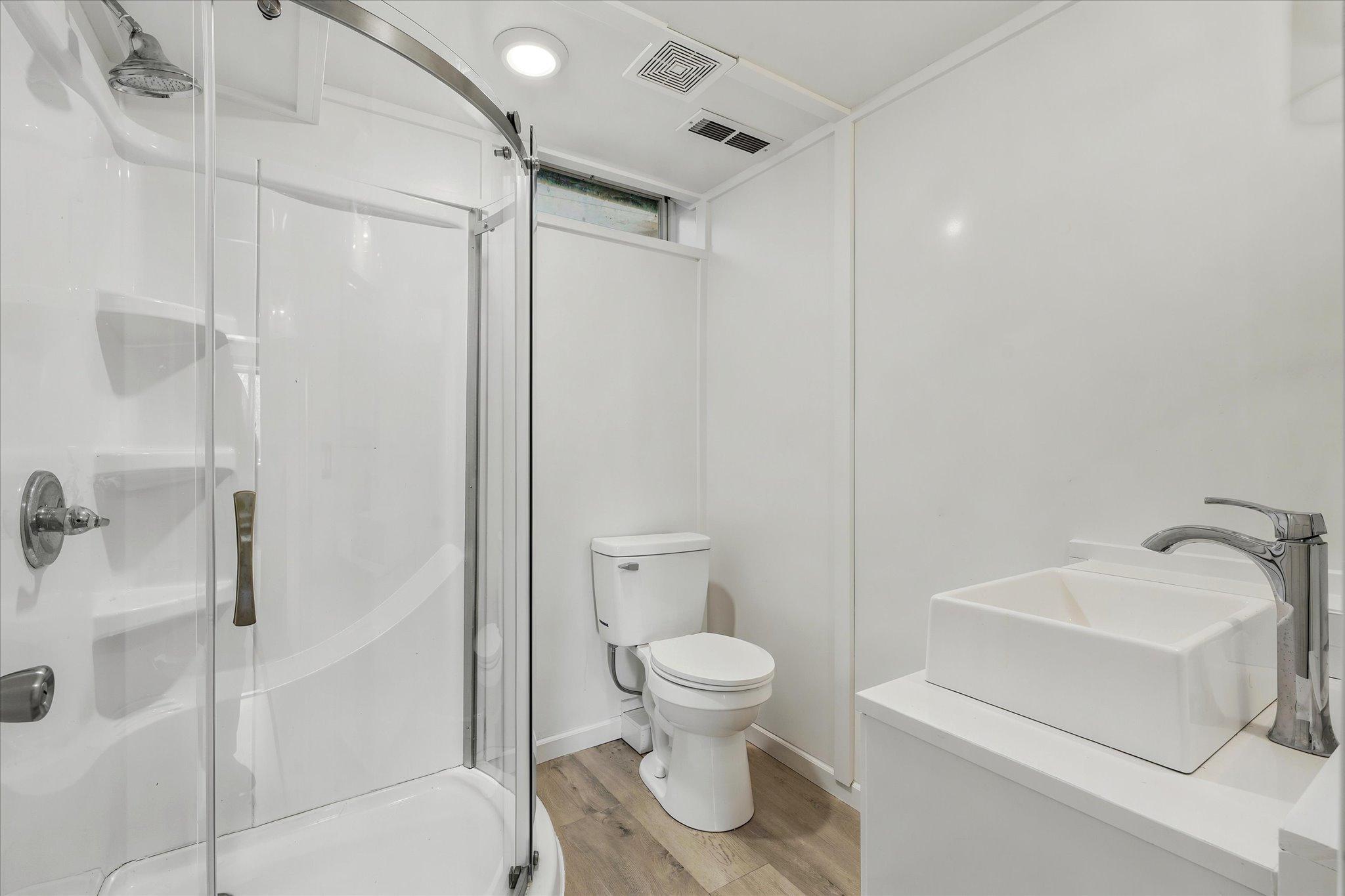Lower level new bathroom. *Keep home as primary, or Approved for ADU/guest house - modifications to complete with your builder. Survey available with new placement for your dream home!
