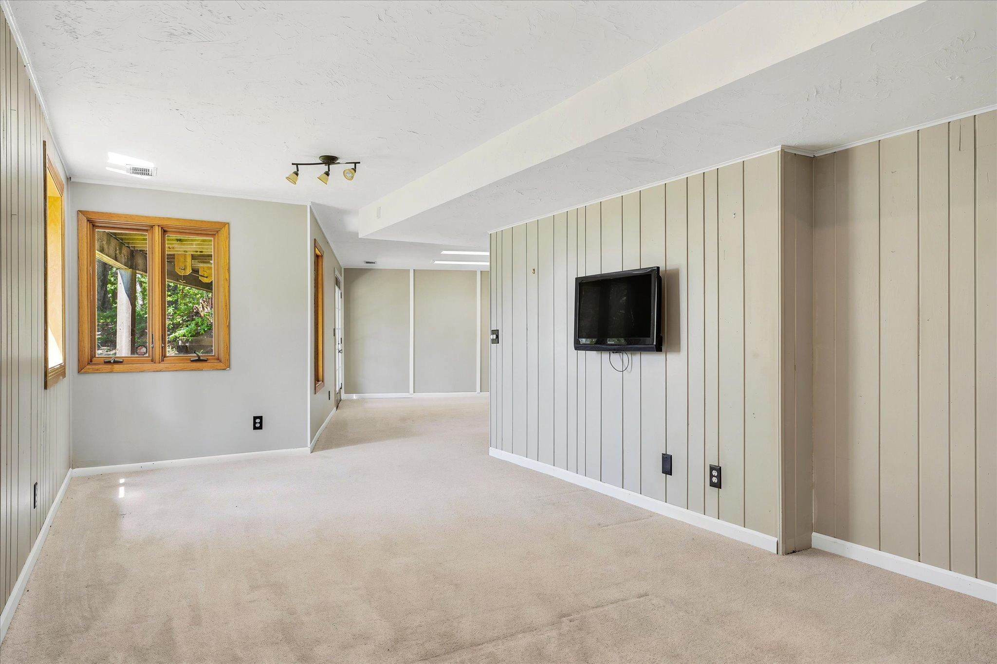 Lower family room *Keep home as primary, or Approved for ADU/guest house - modifications to complete with your builder. Survey available with new placement for your dream home!