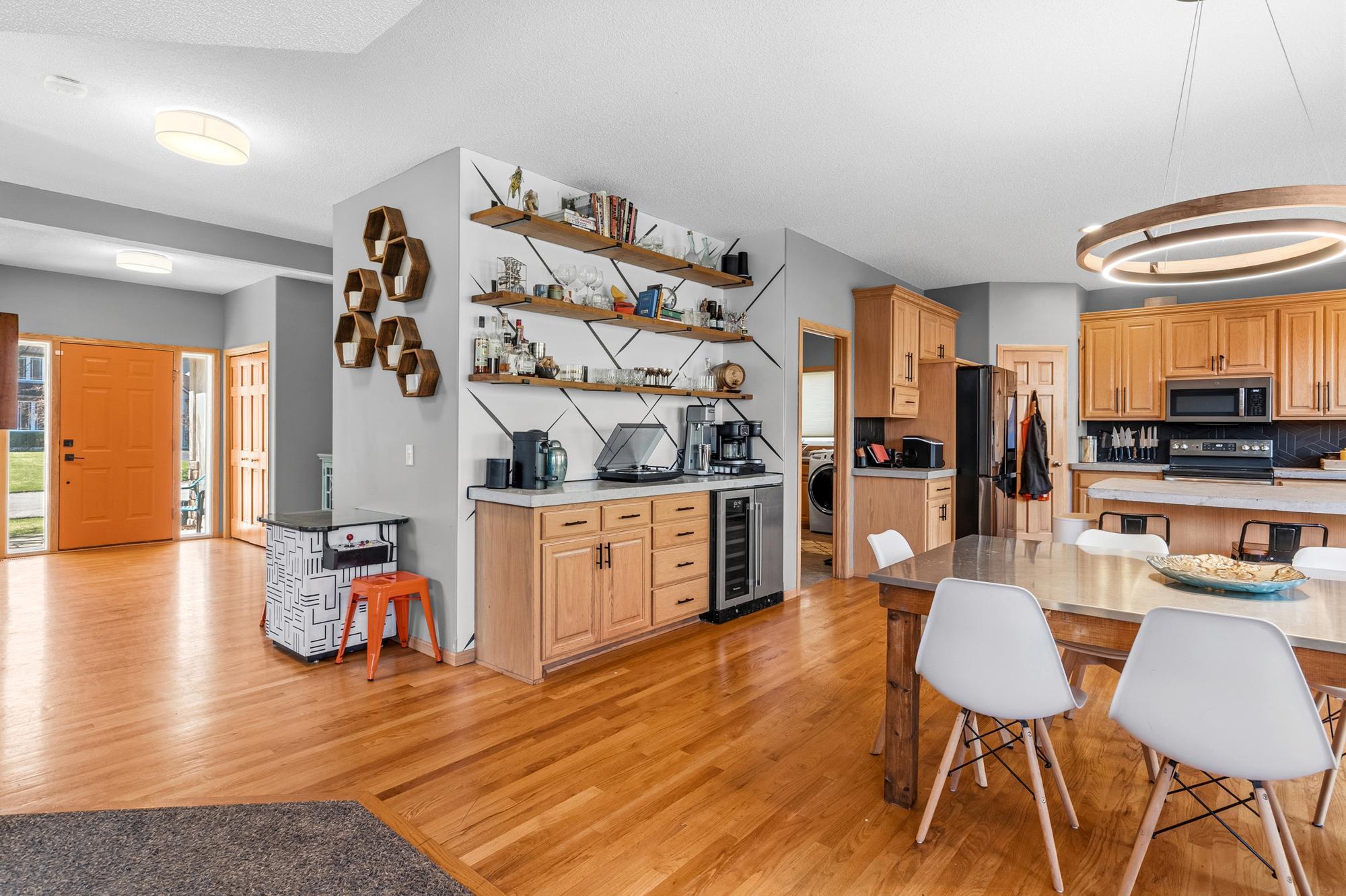 The Kitchen offers a bar area, perfect for when you're entertaining guests. Complete with a wine fridge! The main level has gleaming natural hardwood floors.