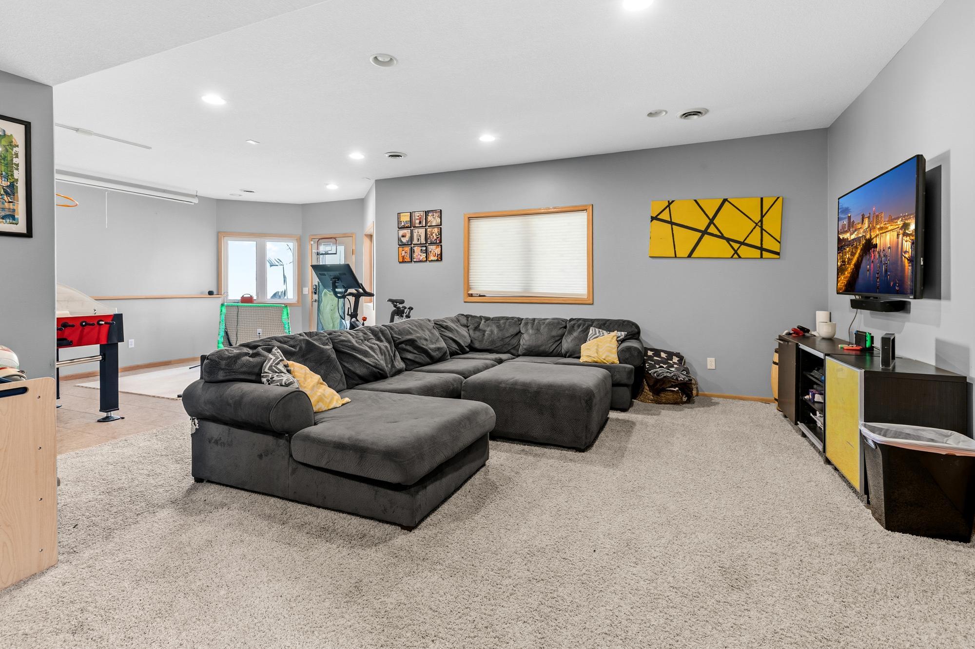 The lower level is bright and welcoming. Featuring in-floor heating. A great place to hang out. Plenty of space for a Family Room as well as a Game Room. The Walkout opens onto the beautifully stamped Patio.