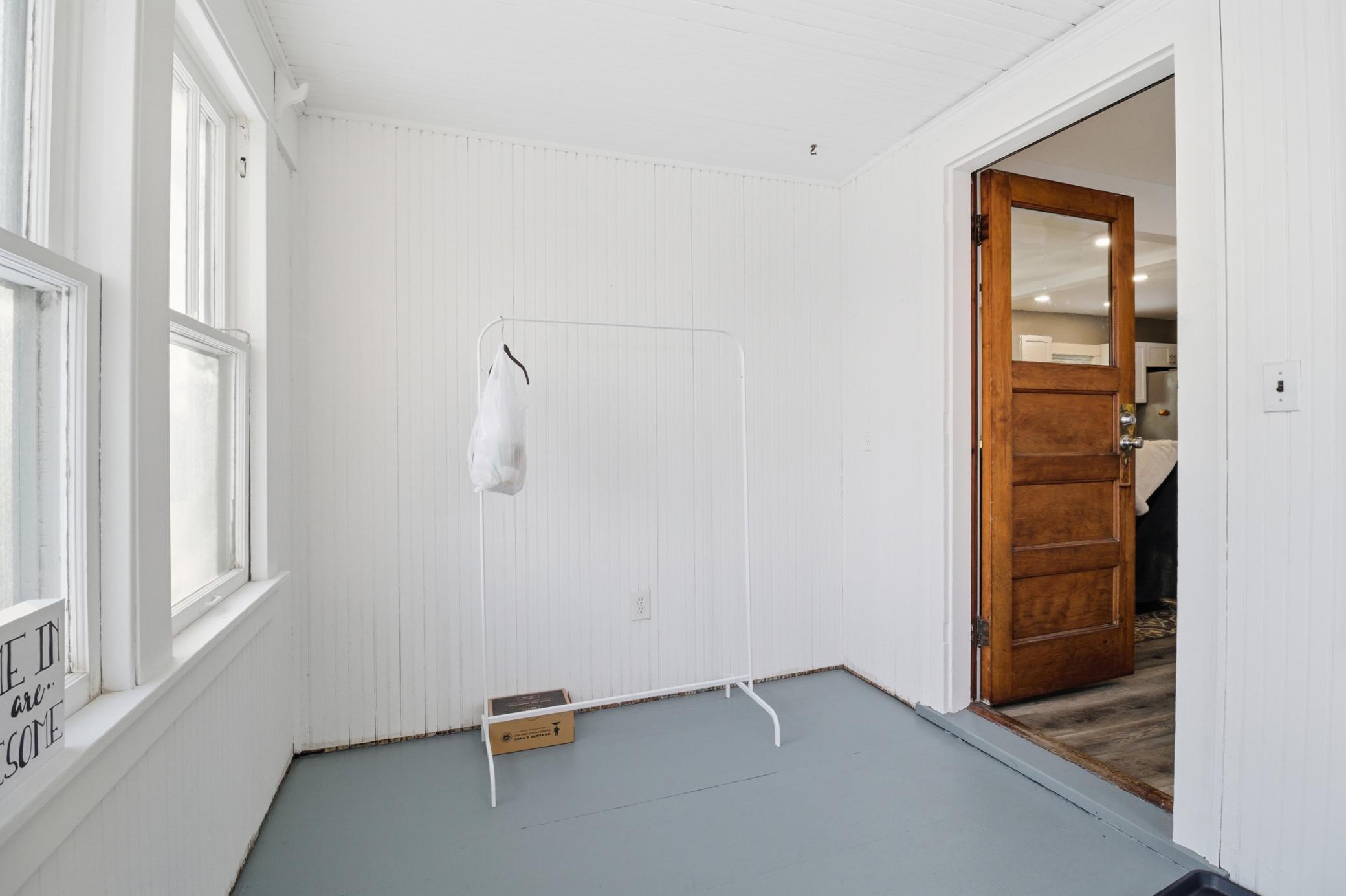 Spacious and light-filled front porch welcomes you in.