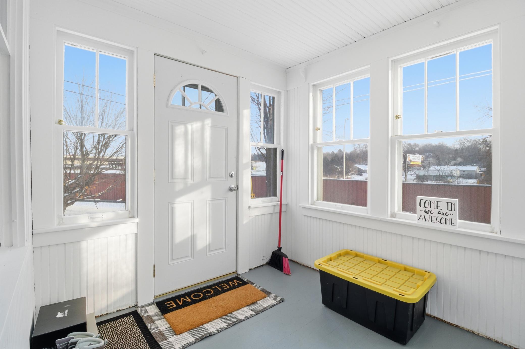 Spacious and light-filled front porch welcomes you in.