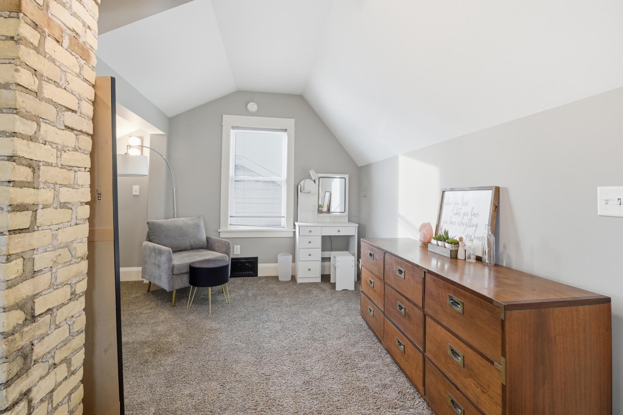 Sellers have used this large space as a bedroom, getting ready area, seating area and make use of all the storage space.