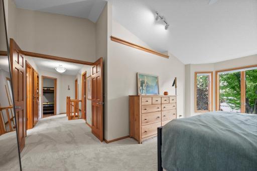 French doors leading to vaulted primary bedroom
