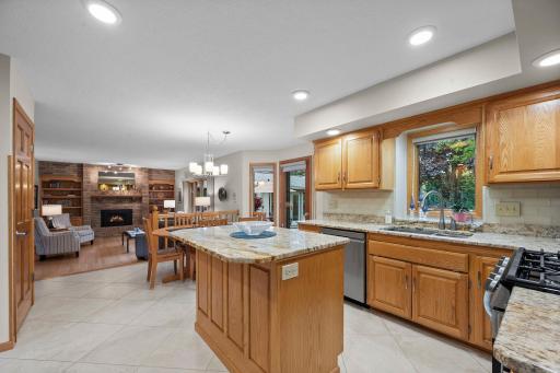 Center island with grantite counter and tile back splash