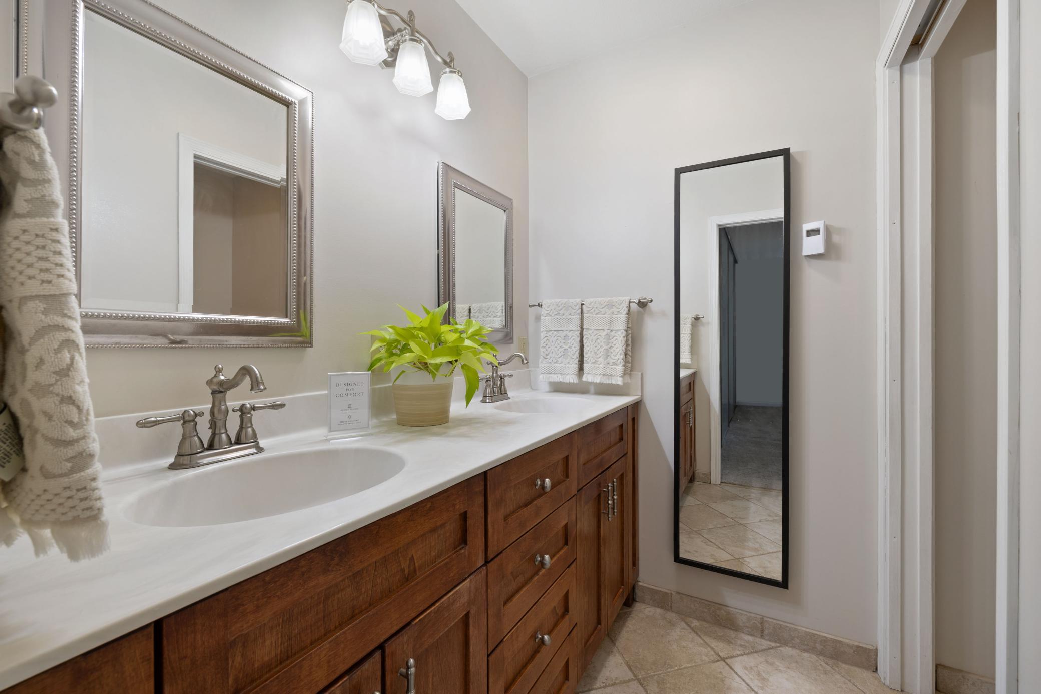 Primary bath with double sinks and heated floor.