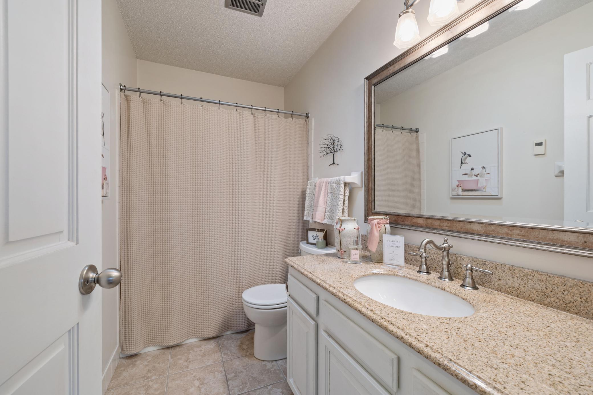 Main bath with tub/shower and heated floor.