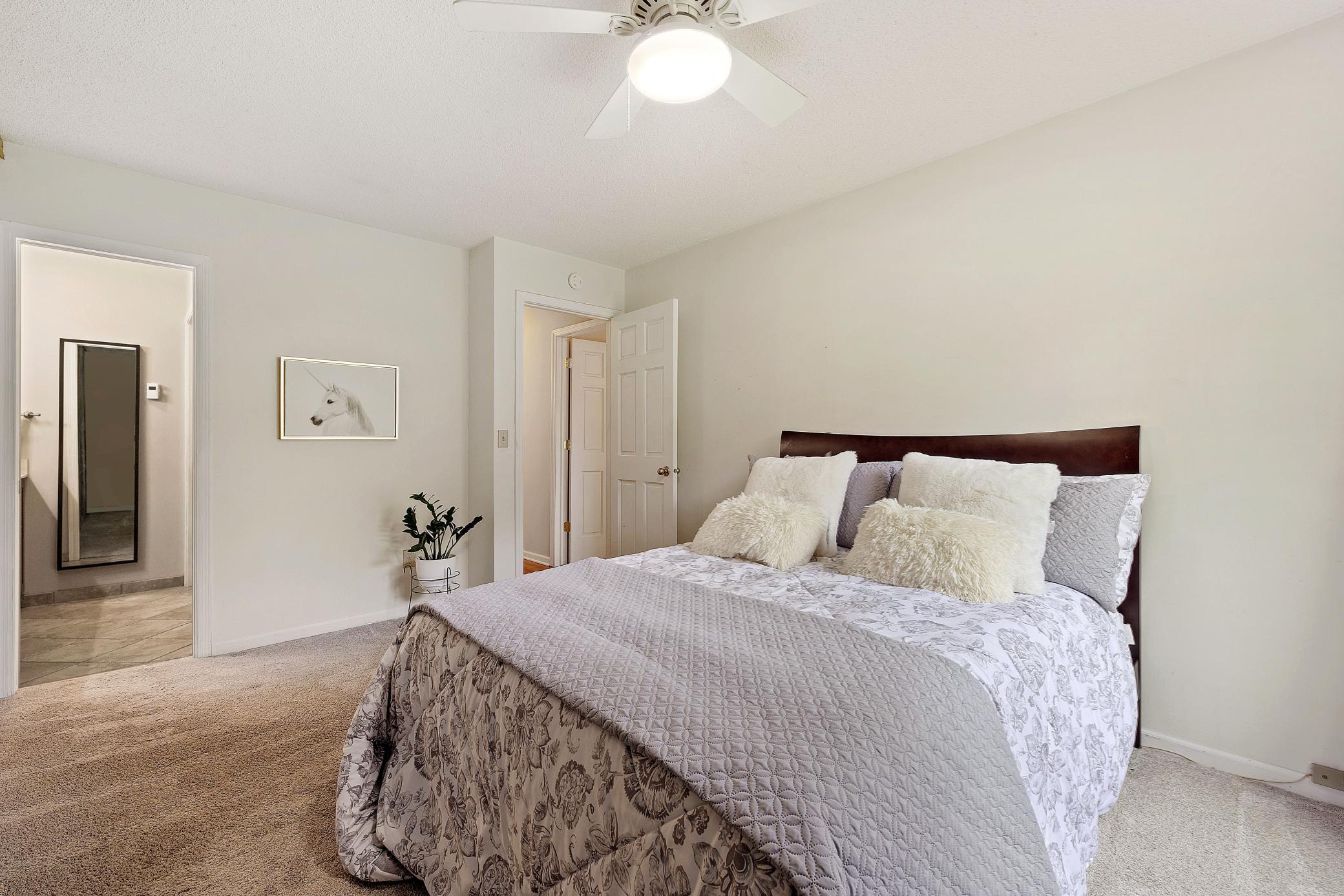 Primary bedroom with ceiling fan.