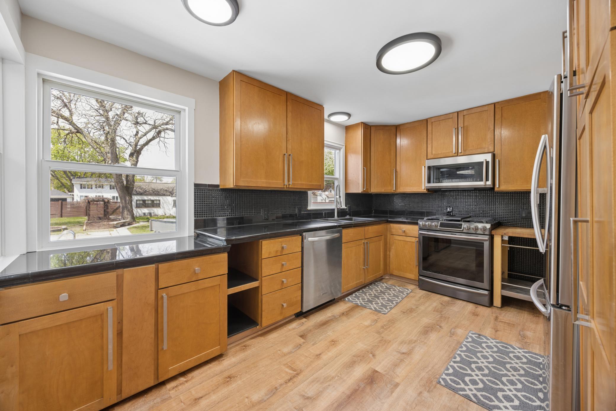 Kitchen has hard surface counter tops, pantry cabinet with great storage & gas stove