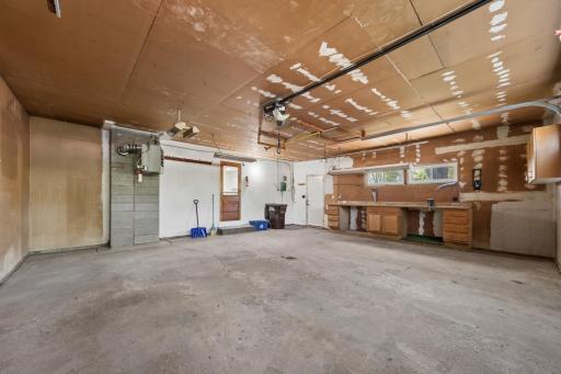 Garage has door to the back yard & work shop area