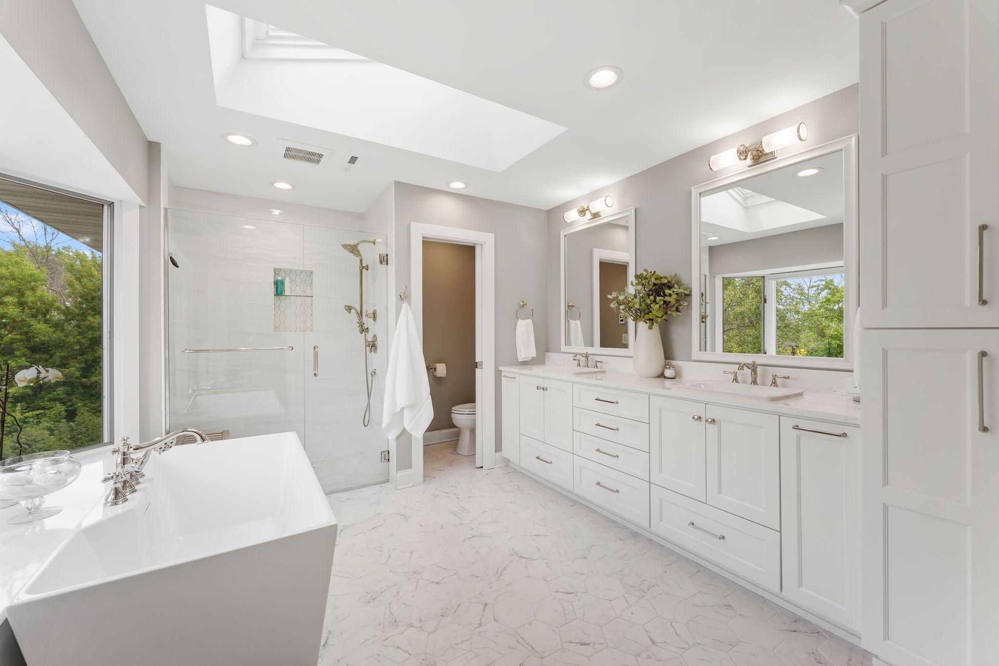 A skylight that drenches this room in sunlight plus heated floors, a sculptured soaking tub, walk in frameless shower with luxury fittings, and a large vanity with dual sinks is the bathroom of your dreams..