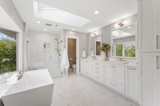 A skylight that drenches this room in sunlight plus heated floors, a sculptured soaking tub, walk in frameless shower with luxury fittings, and a large vanity with dual sinks is the bathroom of your dreams..