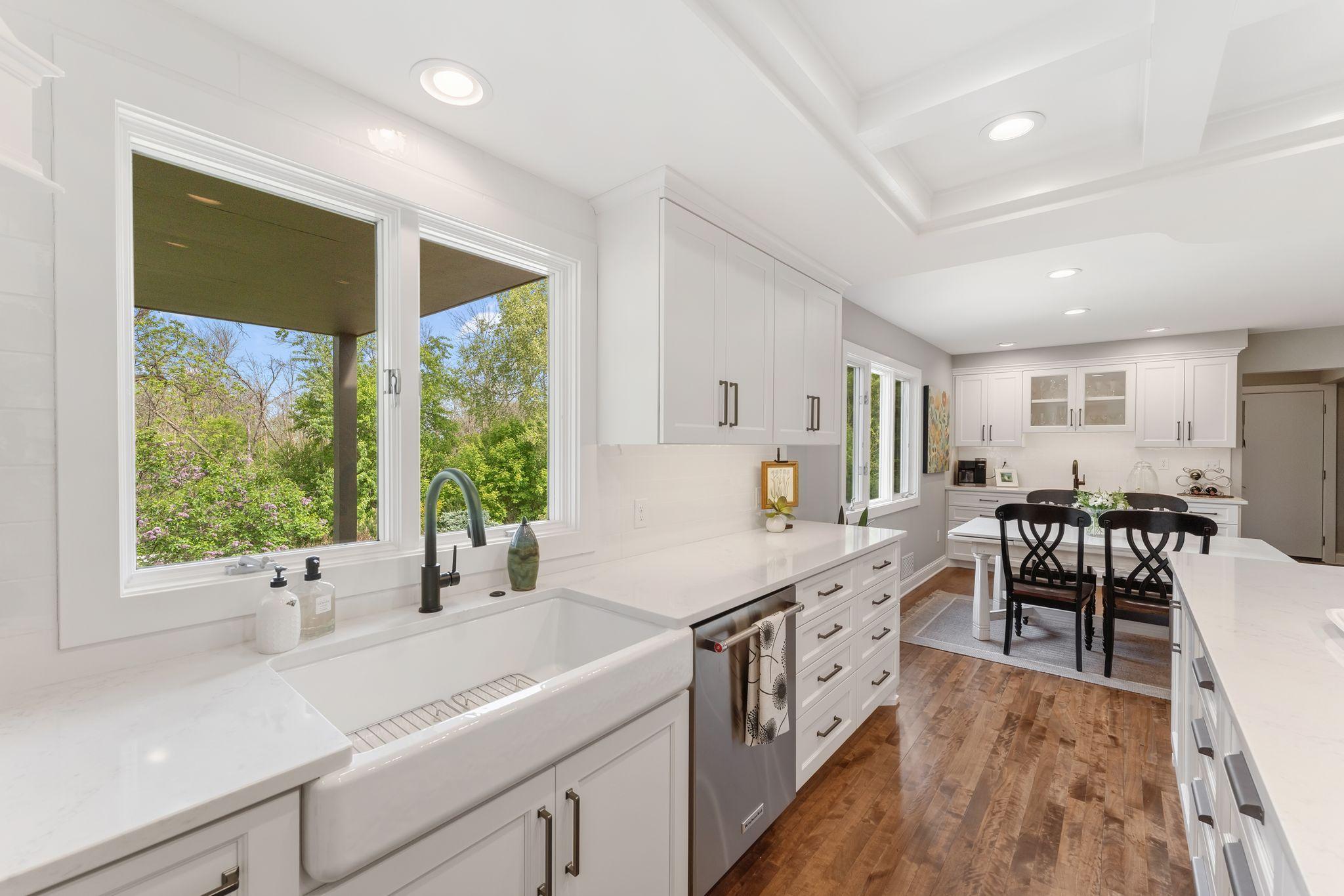 Enameled farmhouse apron front sink with a tree top view