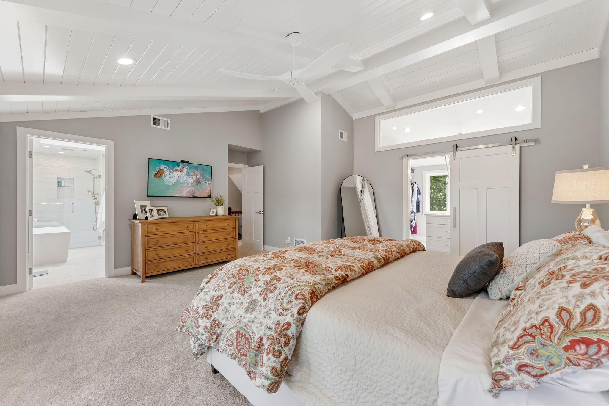 From here you can appreciate the size of this room. Notice the transom window above the barn door leading to the closet.