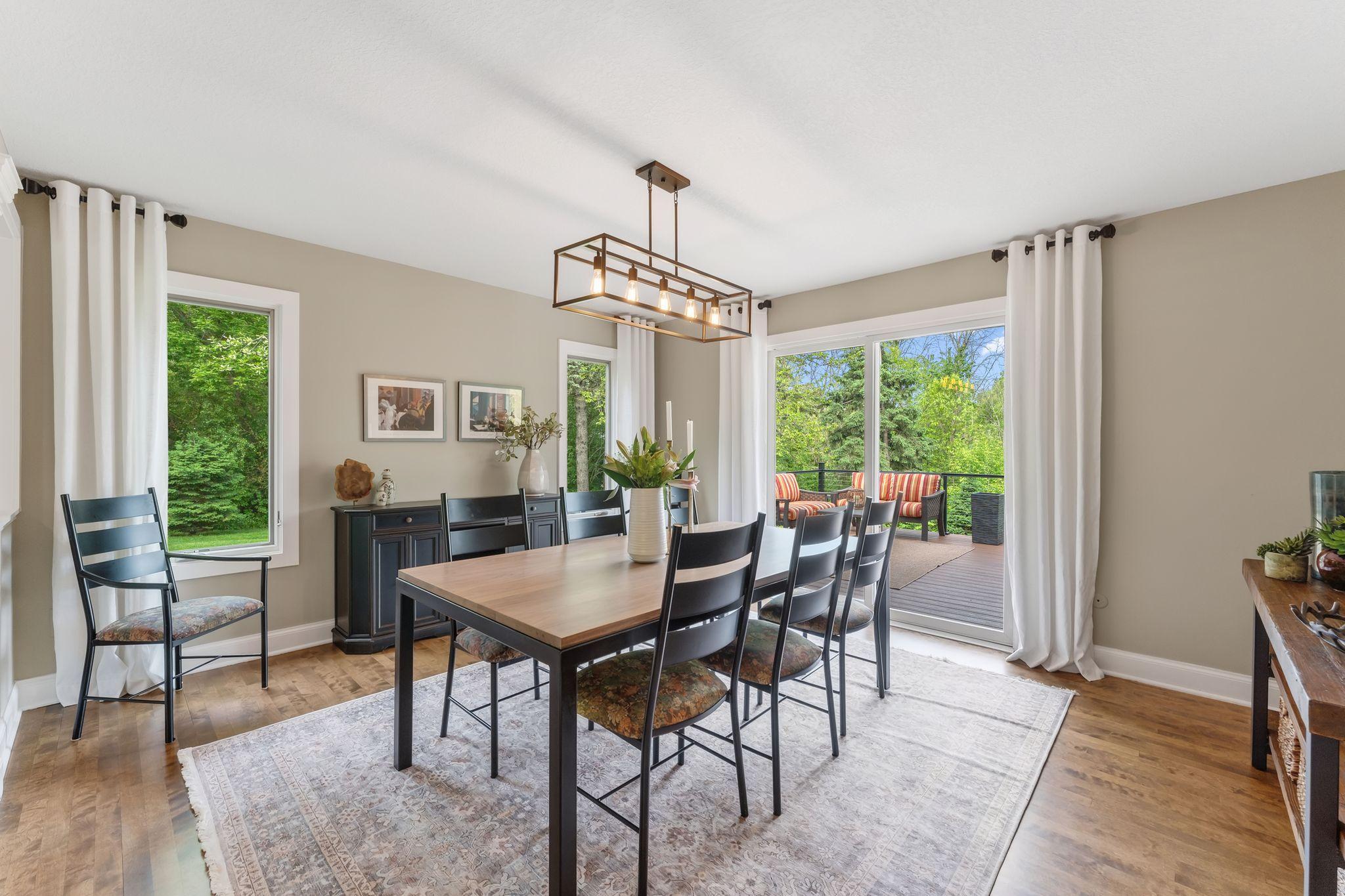The formal dining room connects the living room to the deck and kitchen.