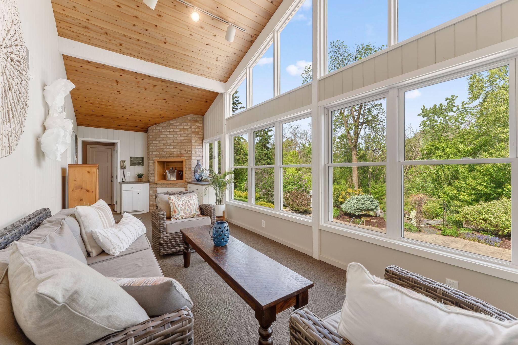 Wall of windows, beamed tongue and groove pine ceiling, a brick serving area and VIEWS FOR DAYS