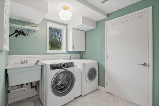 The laundry room is near the walkout in the lower level. This door leads to a 360 square foot unfenced storage room with an overhead garage door!