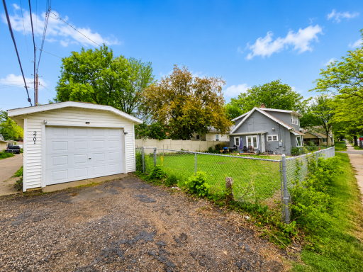 Fully fenced back yard. Detached 1 car garage. -AI edited