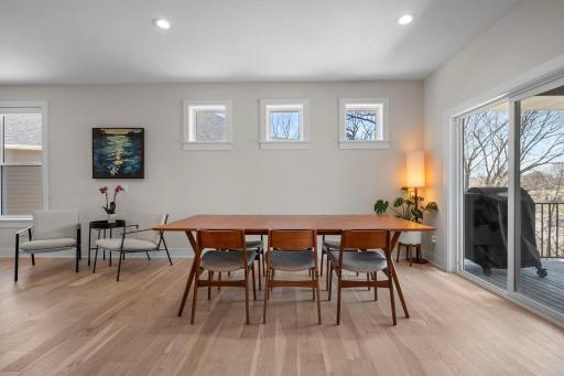 Informal dining room is filled with light & opens to the deck