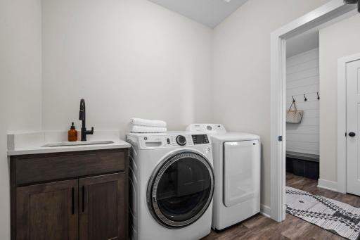 Walkthrough the primary suite to the laundry room that includes a new 5.0 cu ft washing machine
