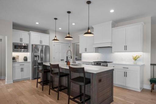 Enjoy the gorgeous chef's kitchen with stainless appliances, stone counters, tile backsplash, pantry & a large island