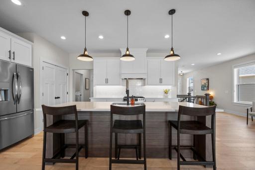 Additional seating at the center island adds both function and a perfect spot for gathering