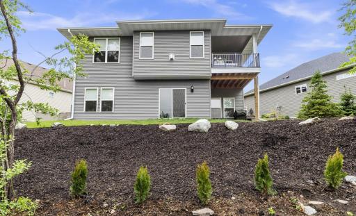 The backyard offers a beautiful garden area, with new arborvitaes recently planted to create additional privacy and offer greenery year round