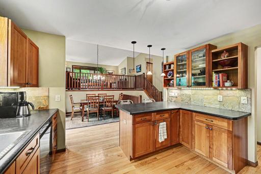Open main floor feel, natural tile backsplash, wood floors, half bathroom, dining area and open to the large deck 24 x 12.