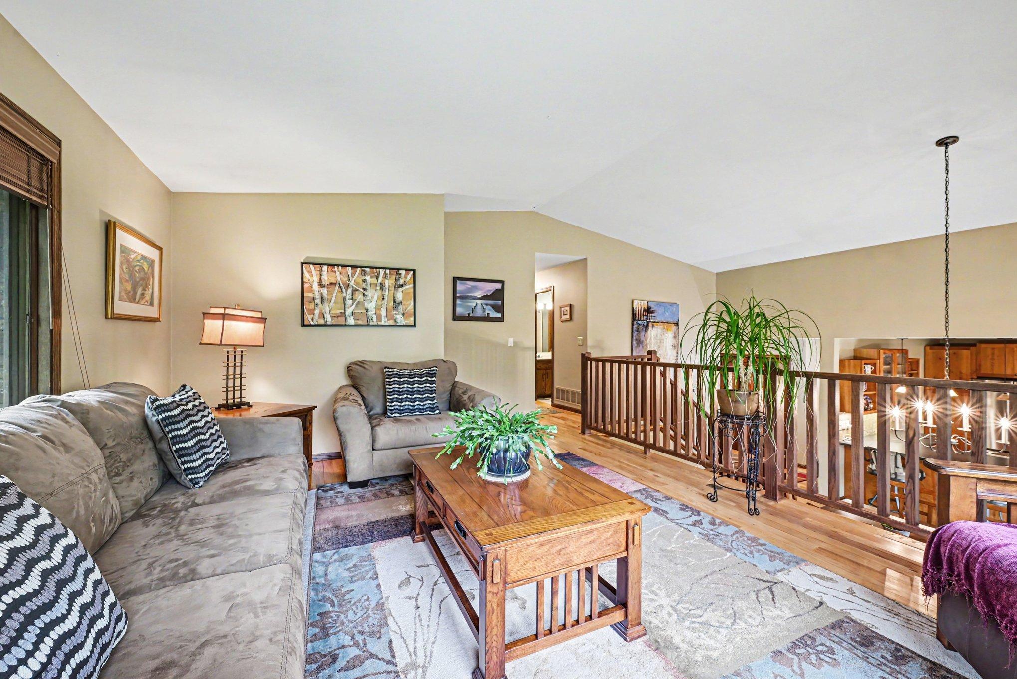 Upper living room surrounded by windows