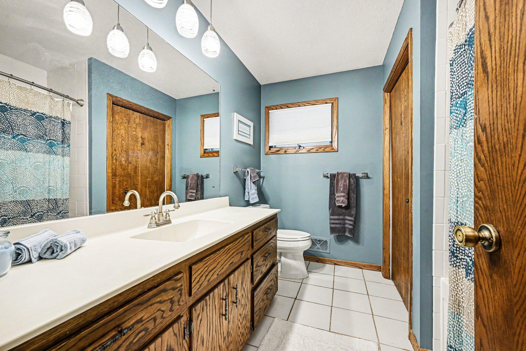 Upper level full bathroom with soaking tub, ceramic tile and large vanity and linen closet. The upper hall closet has laundry hook ups.