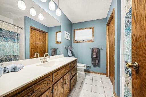 Upper level full bathroom with soaking tub, ceramic tile and large vanity and linen closet. The upper hall closet has laundry hook ups.