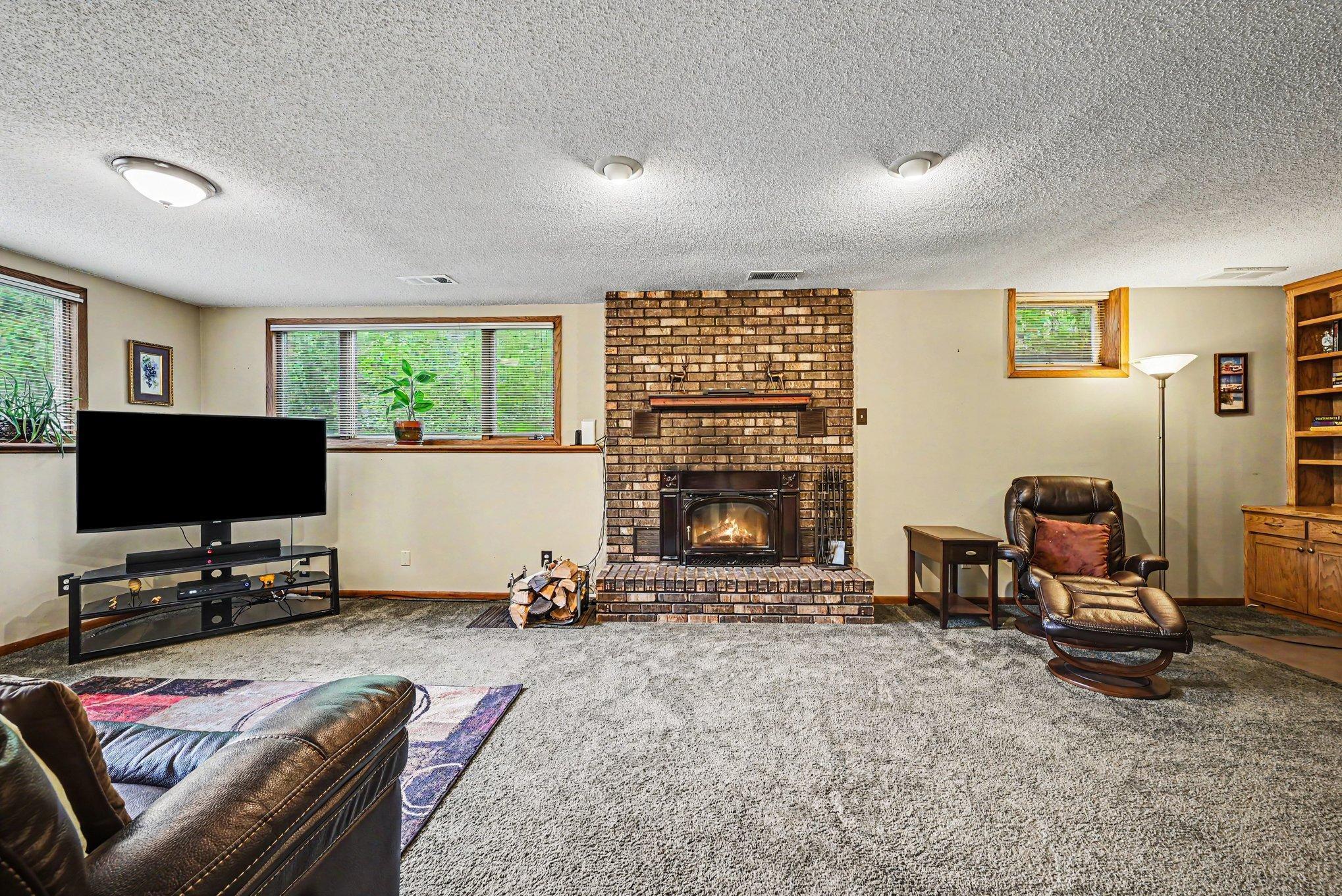 Additional features include a roof replaced in 2020, septic system is in compliance. Well-maintained mechanicals and a wood-burning fireplace in the lower-level family room.