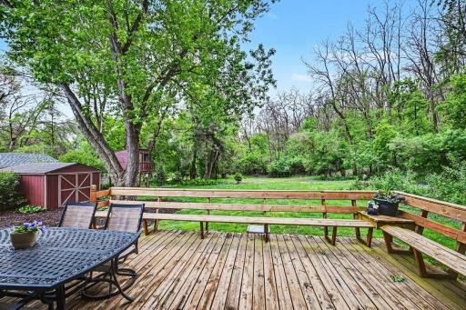 The backyard is filled with blooming perennial gardens, mature trees, a nature trails, a playhouse, and a storage shed, creating your own private sanctuary of peace and tranquility