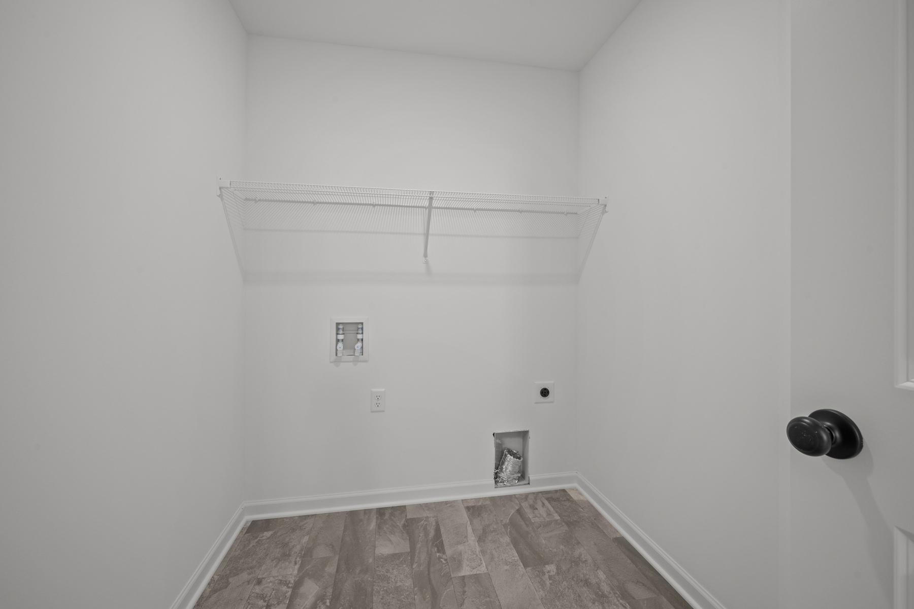 Dedicated laundry room in the McBee plan designed for everyday efficiency and organization. Images are from a similar home, interior selections may differ