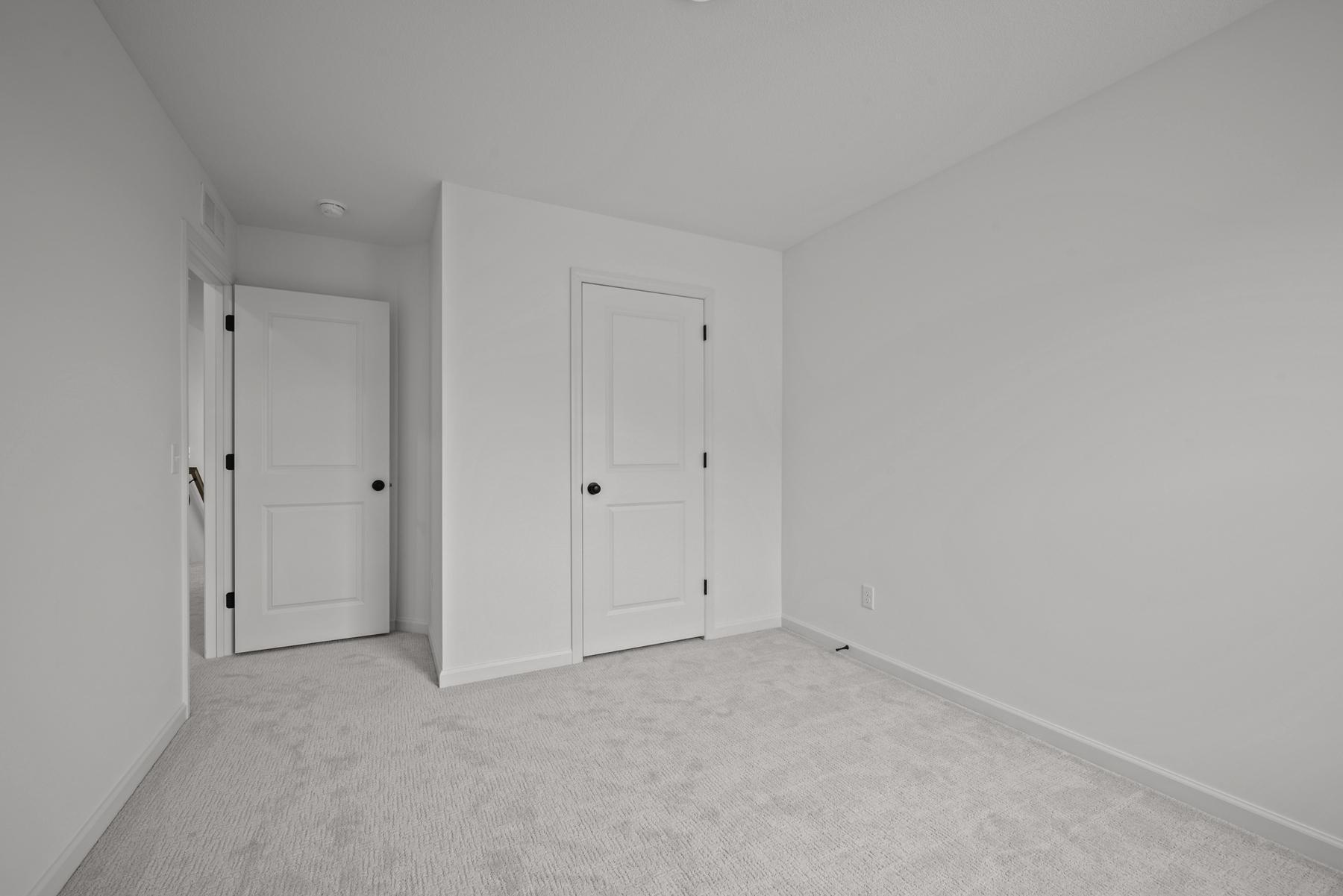 Comfortable secondary bedroom in the McBee plan ideal for guests or family use. Images are from a similar home, interior selections may differ